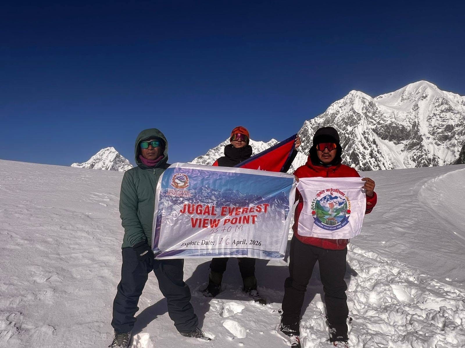 Team at the top of Jugal Everest View Point, 5,570 m, with the Nepal flag